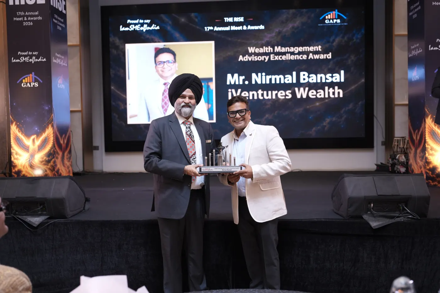 Two men holding the Wealth Management Advisory Excellence Award trophy on stage at The RISE 17th Annual Meet & Awards 2026, in front of a large screen naming iVentures Wealth